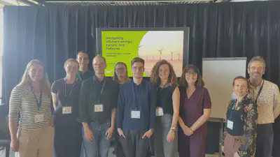 The conveners of the session standing in front of the opening slide.