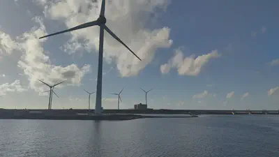 Wind turbines at Neeltje Jans against a cloudy sky.